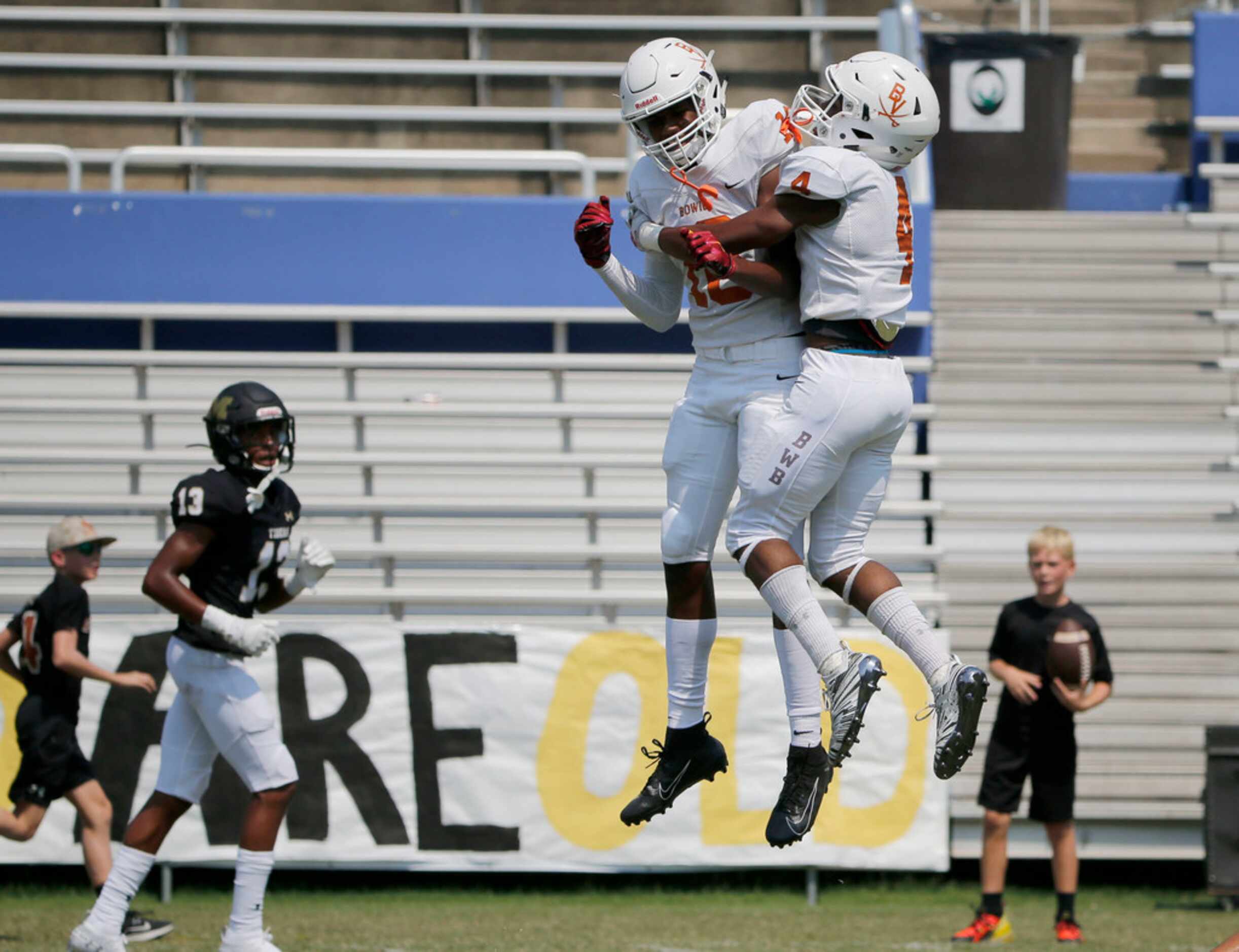 Arlington Bowie's Jimmy Valsin (18) celebrates with Trint Scott (4) after Scott scored a...