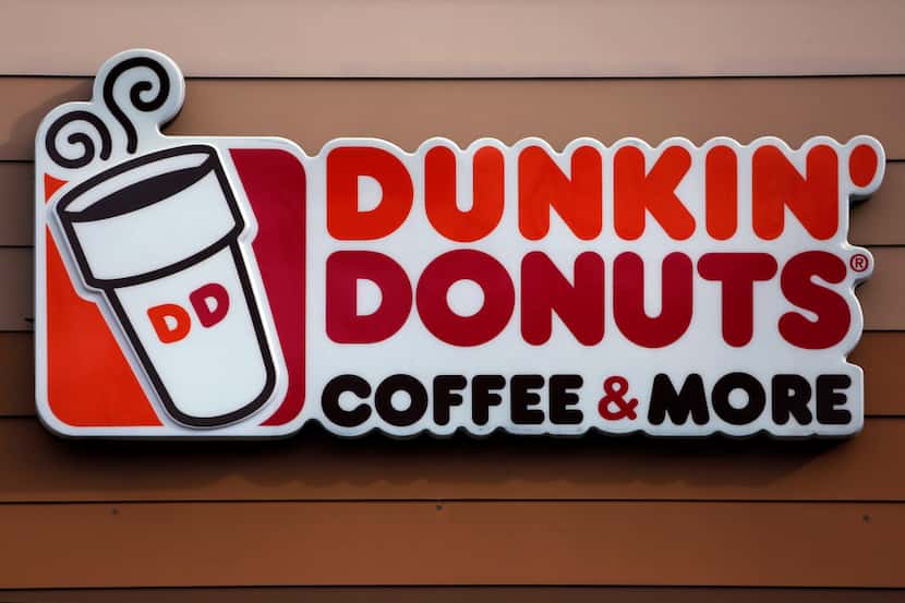 FILE- In this Jan. 22, 2018, file photo shows the Dunkin' Donuts logo on a shop in Mount...