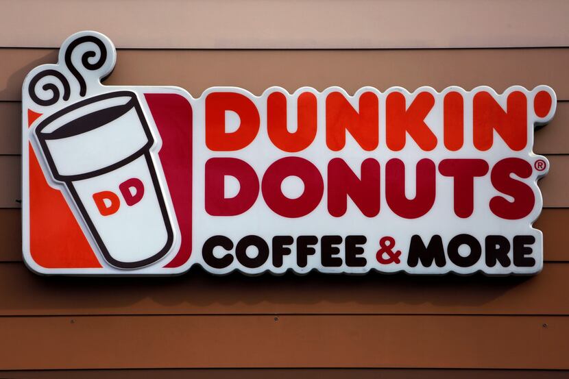 FILE- In this Jan. 22, 2018, file photo shows the Dunkin' Donuts logo on a shop in Mount...