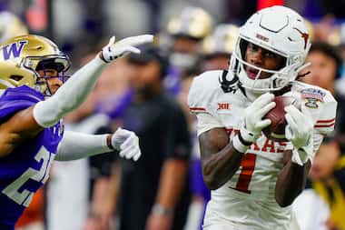 FILE - Texas wide receiver Xavier Worthy (1) makes a catch while covered by Washington...