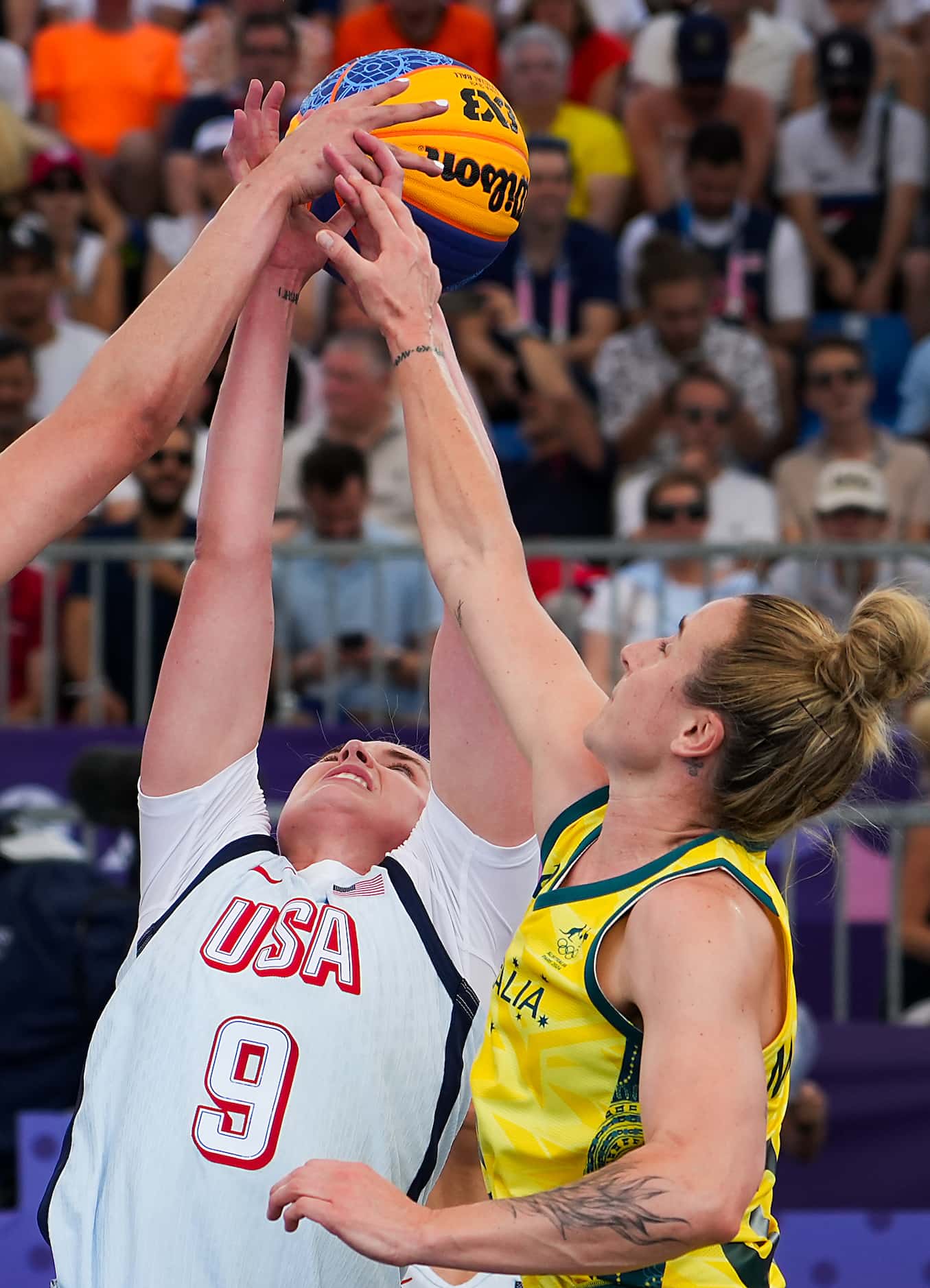 Hailey van Lith of the United States (9) fights for a rebound against Lauren Mansfield (33)...