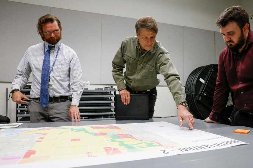 North Dallas resident Bruce Wilke (center) points to a map of north central Dallas as he...