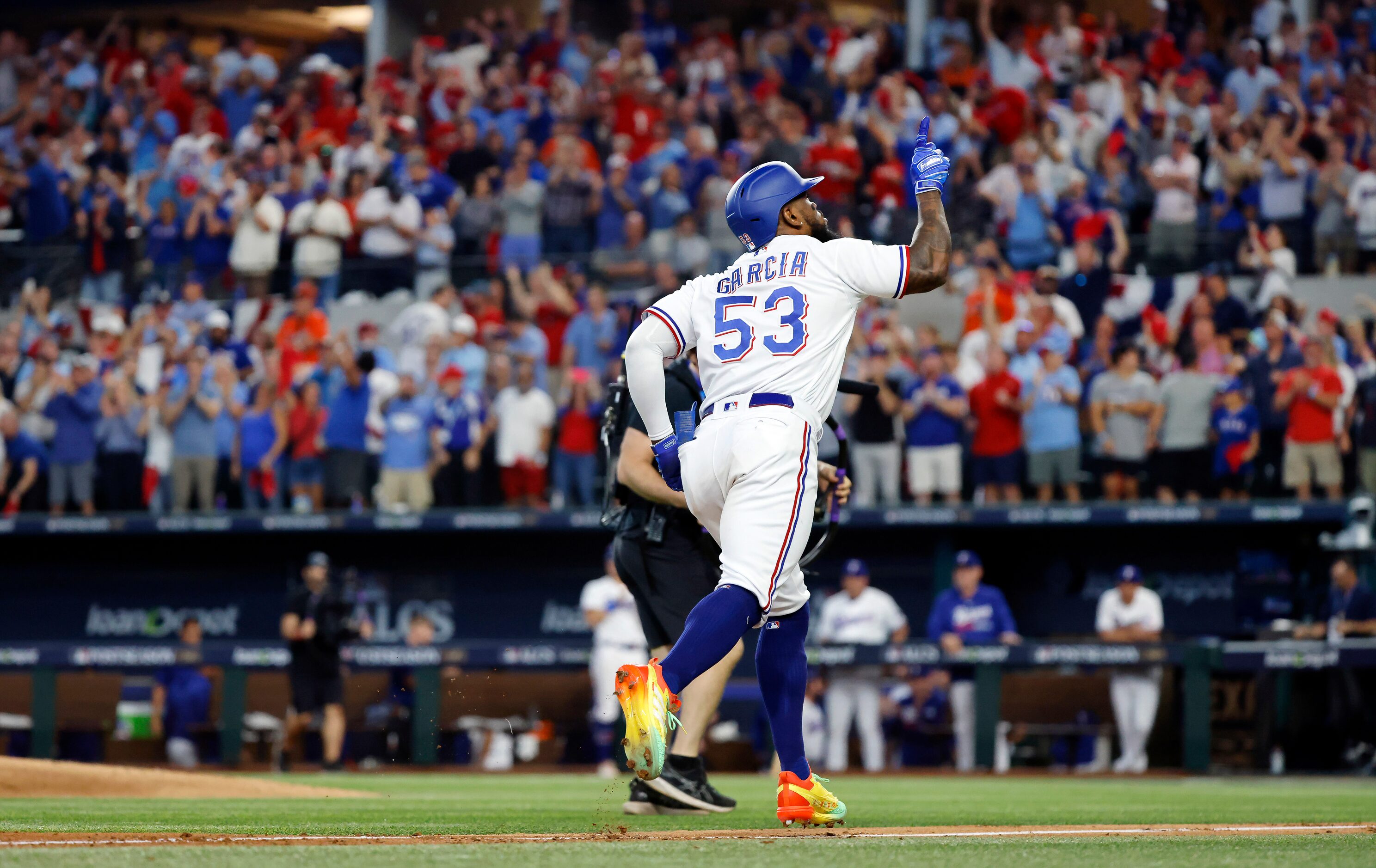 Texas Rangers batter Adolis Garcia (53) points skyward after hitting a three-run homer off...