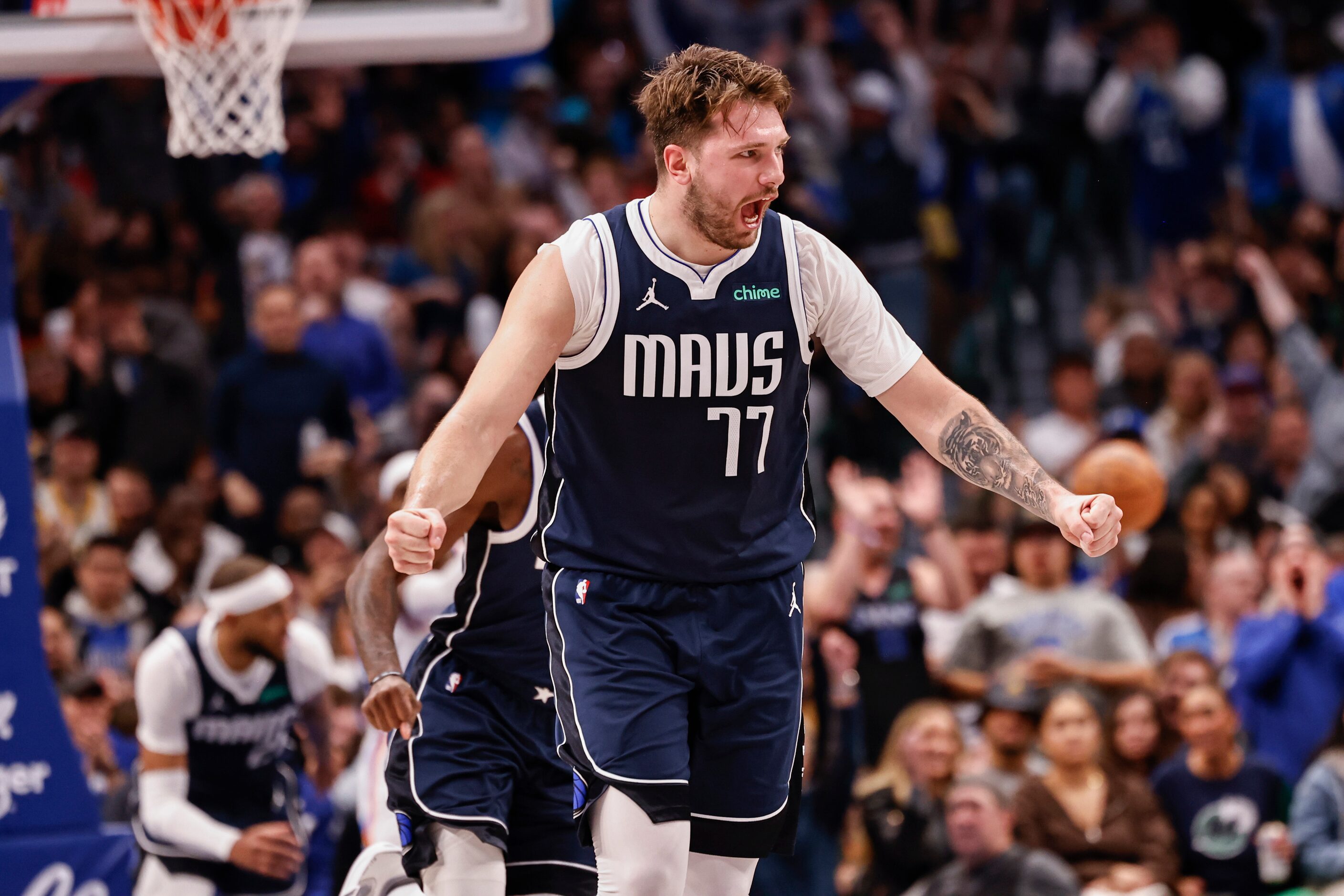 Dallas Mavericks guard Luka Dončić (77) celebrates after Dallas Mavericks center Daniel...