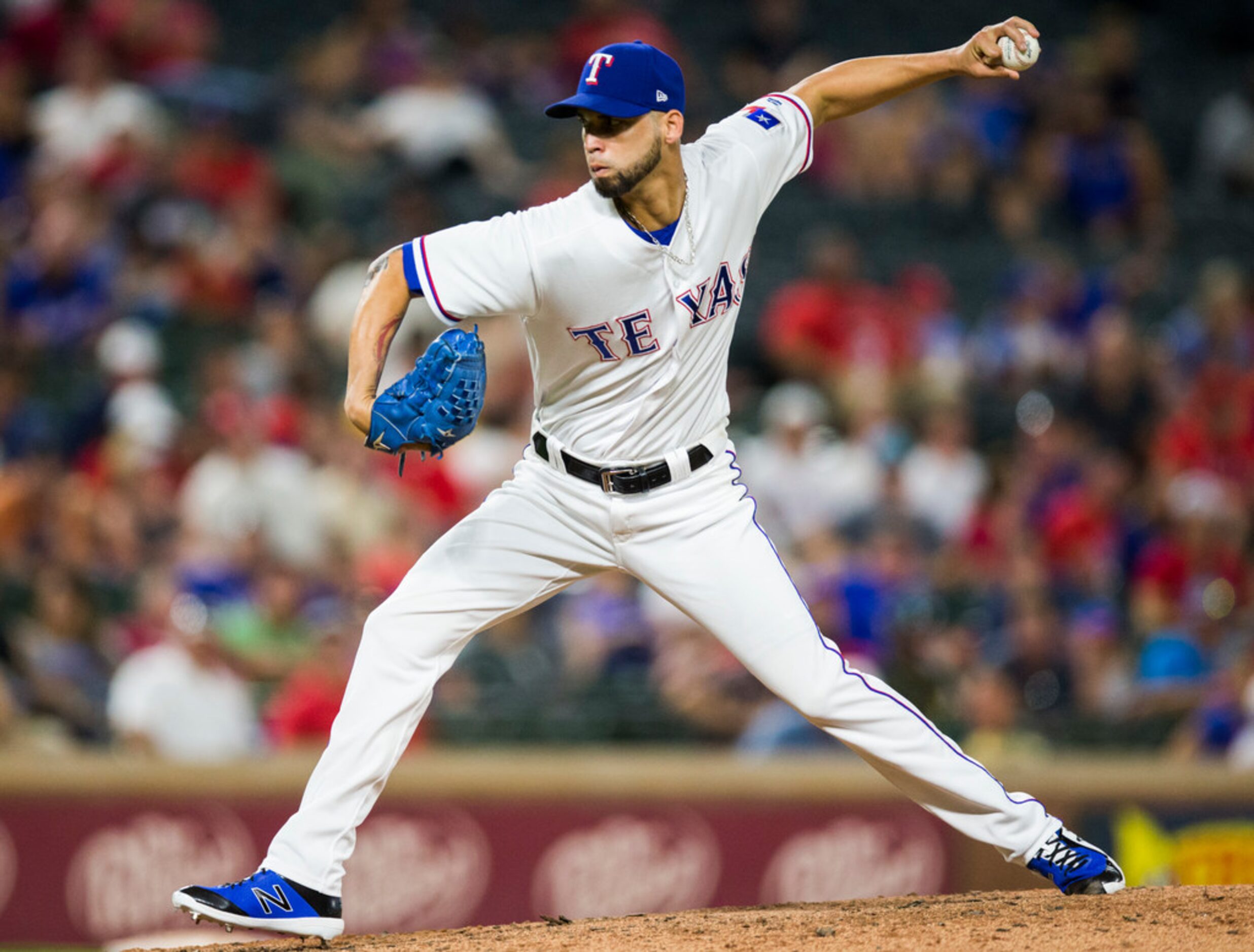 Texas Rangers relief pitcher Alex Claudio (58) pitches in the eighth inning of an MLB game...