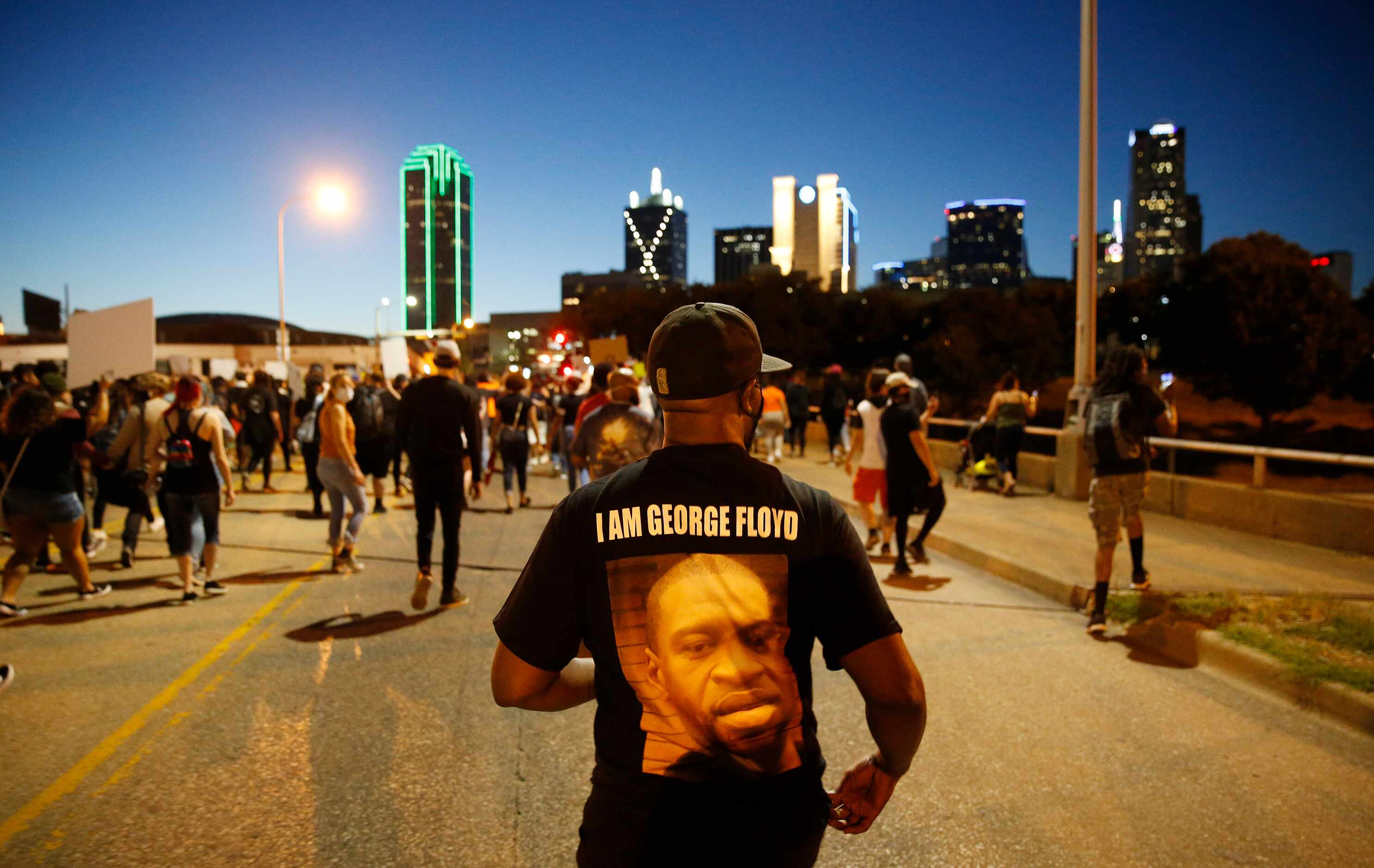 Protesters march during a demonstration against police brutality in downtown Dallas, on...