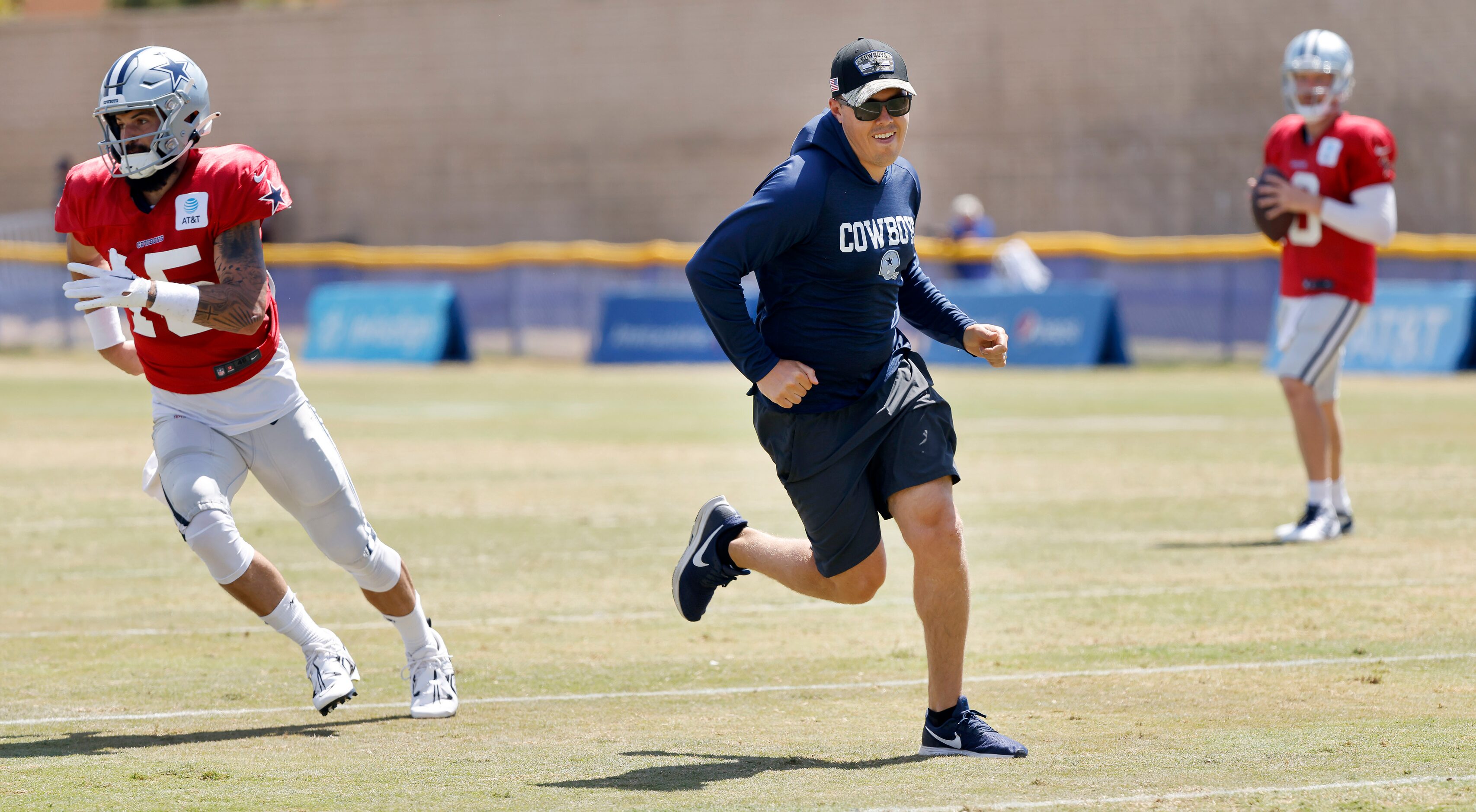 Dallas Cowboys offensive coordinator Kellen Moore (center) runs a pass route during...