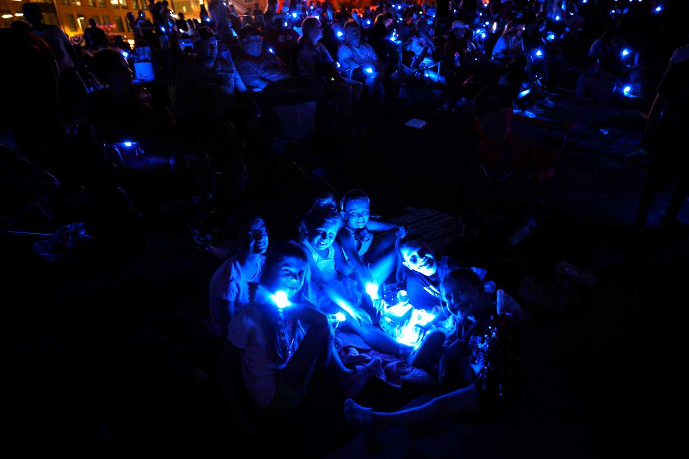 People wear LED bracelets during an LED bracelet experience at the third annual Sensory...