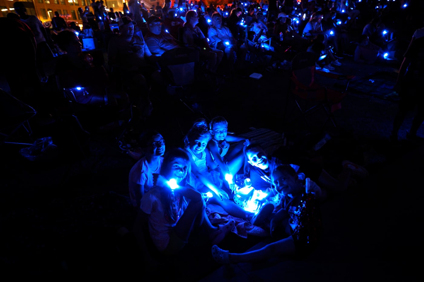 People wear LED bracelets during an LED bracelet experience at the third annual Sensory...