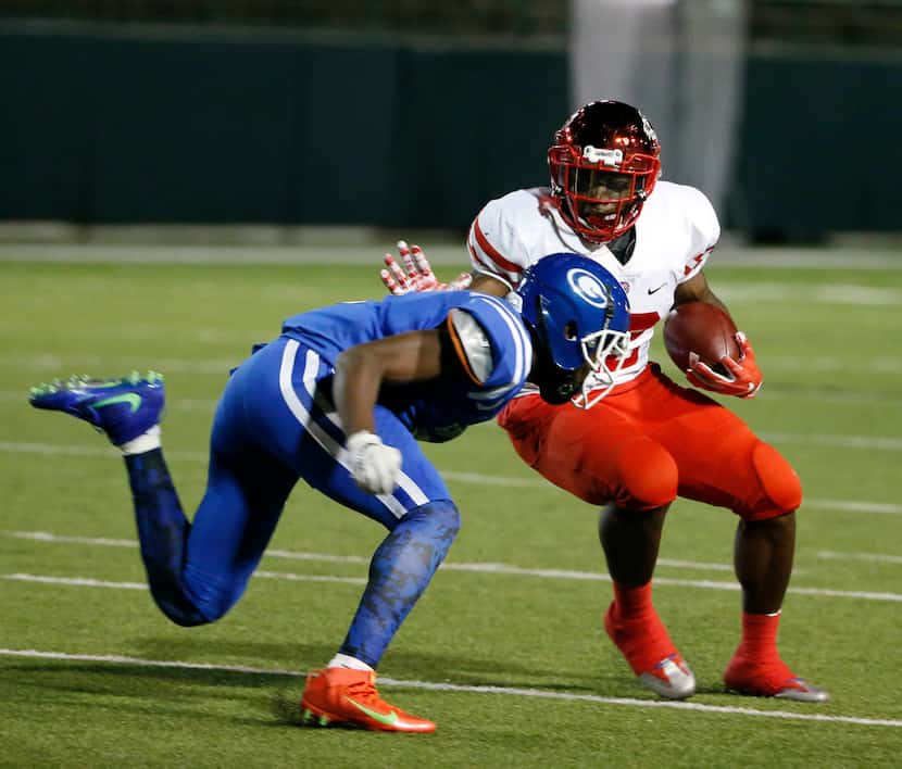 Duncanville's Kelion Elder (22) tries to get past Grand Prairie's  Reggie Williams (5) ...