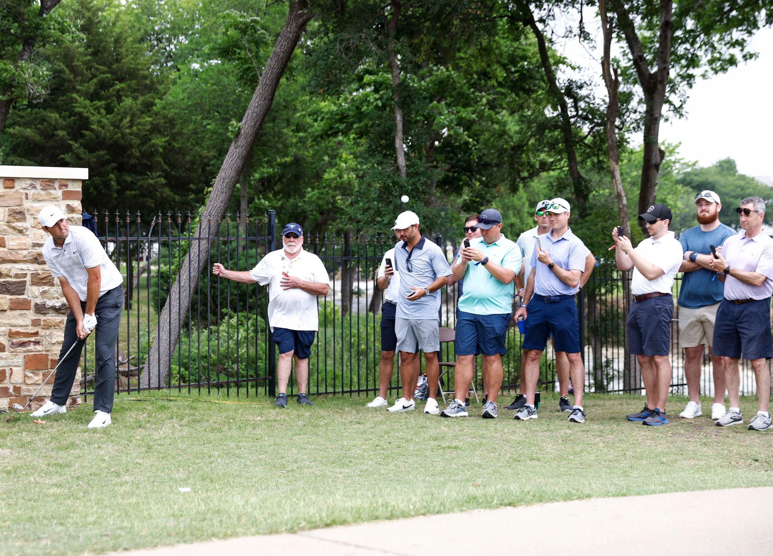 Scottie Scheffler of United States chips to the green of the eighth hole during the second...