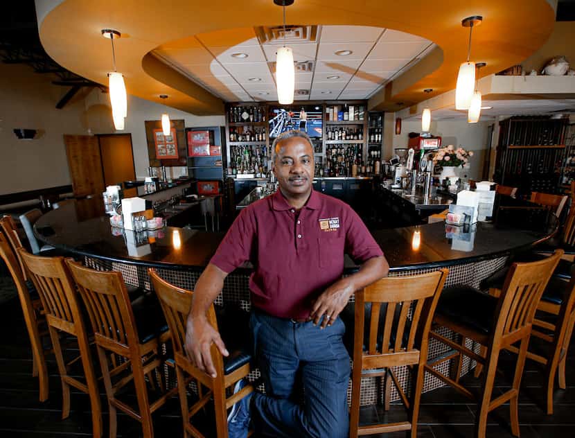 Kassahun Kebede, an immigrant from Ethiopia, stands in his restaurant, Yenat Guada Ethiopian...