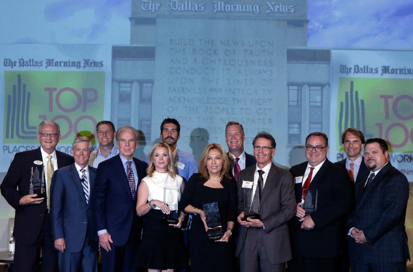 Top officers from the winning companies posed after the Top 100 Places to Work luncheon...