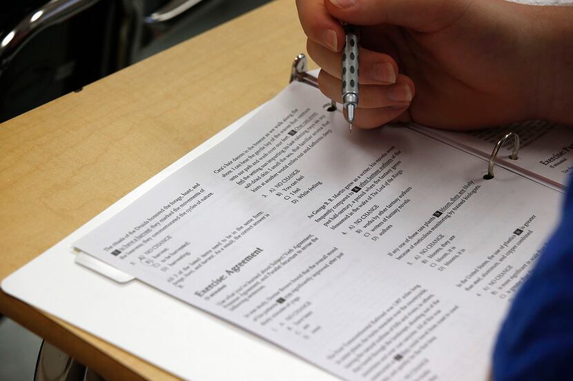 In this photo taken Jan. 17, 2016, a student looks at questions during a college test...