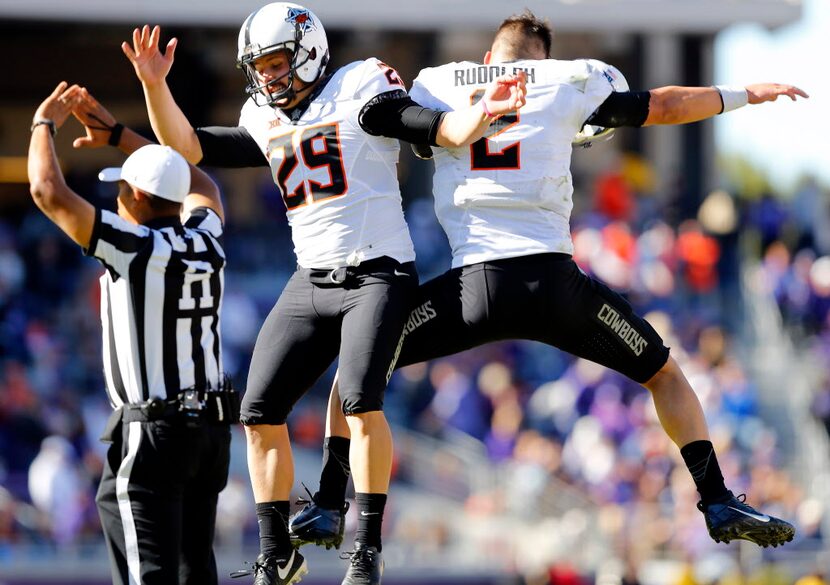 Oklahoma State Cowboys quarterback Mason Rudolph (2) and teammate Zach Sinor (29) celebrate...