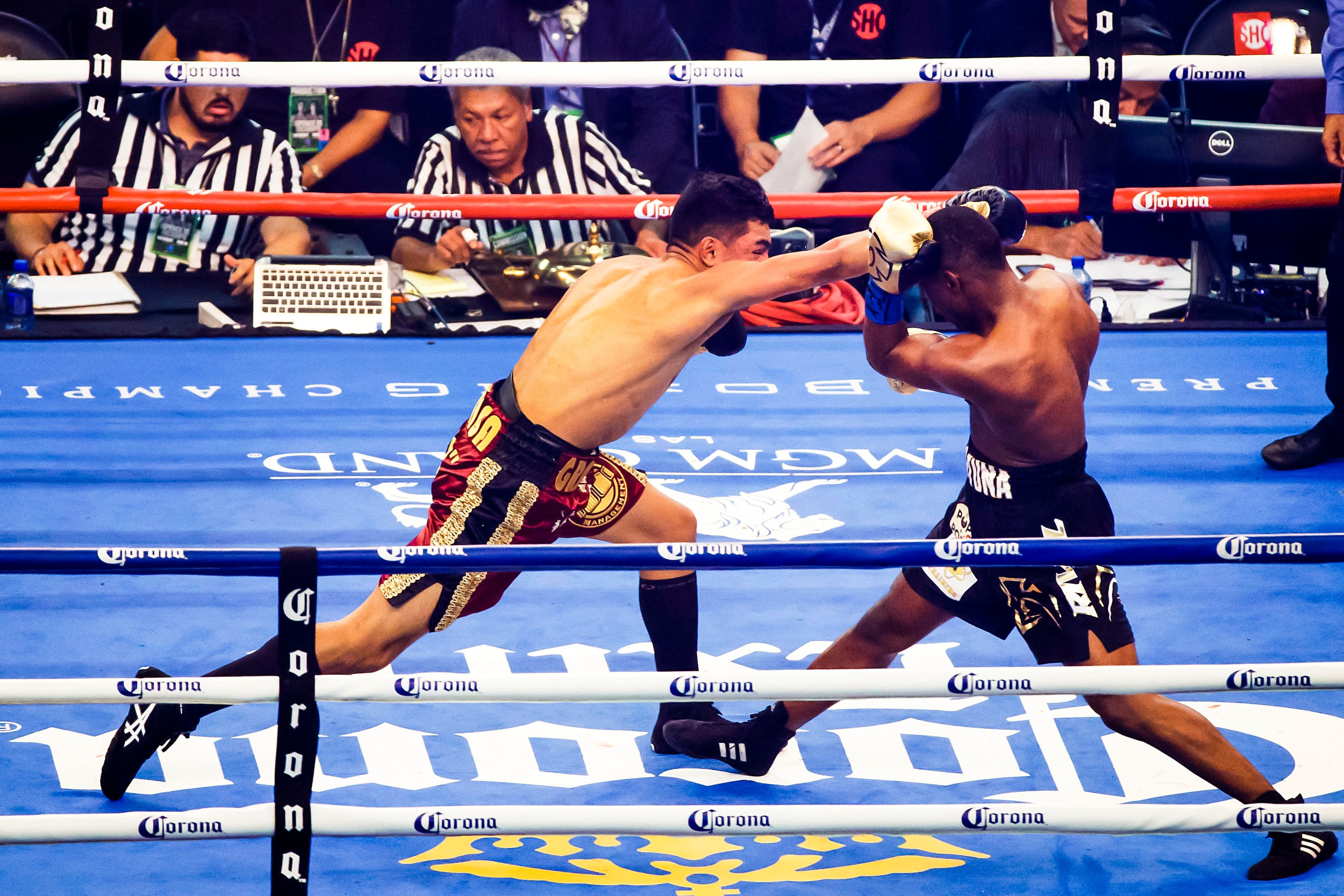 Javier Fortuna (right), of La Romana, Dominican Republic, fights Adrian Granados, of...