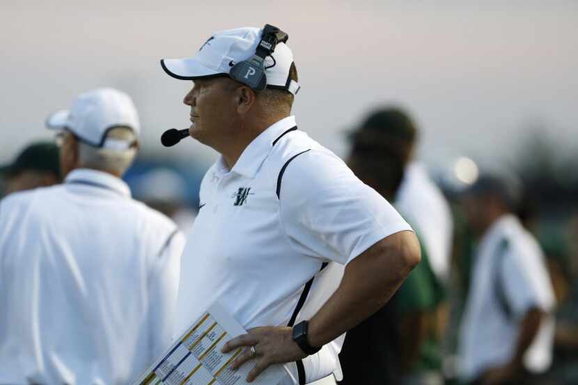 Waxahachie coach Jon Kitna watches the field in the first quarter of the game between...