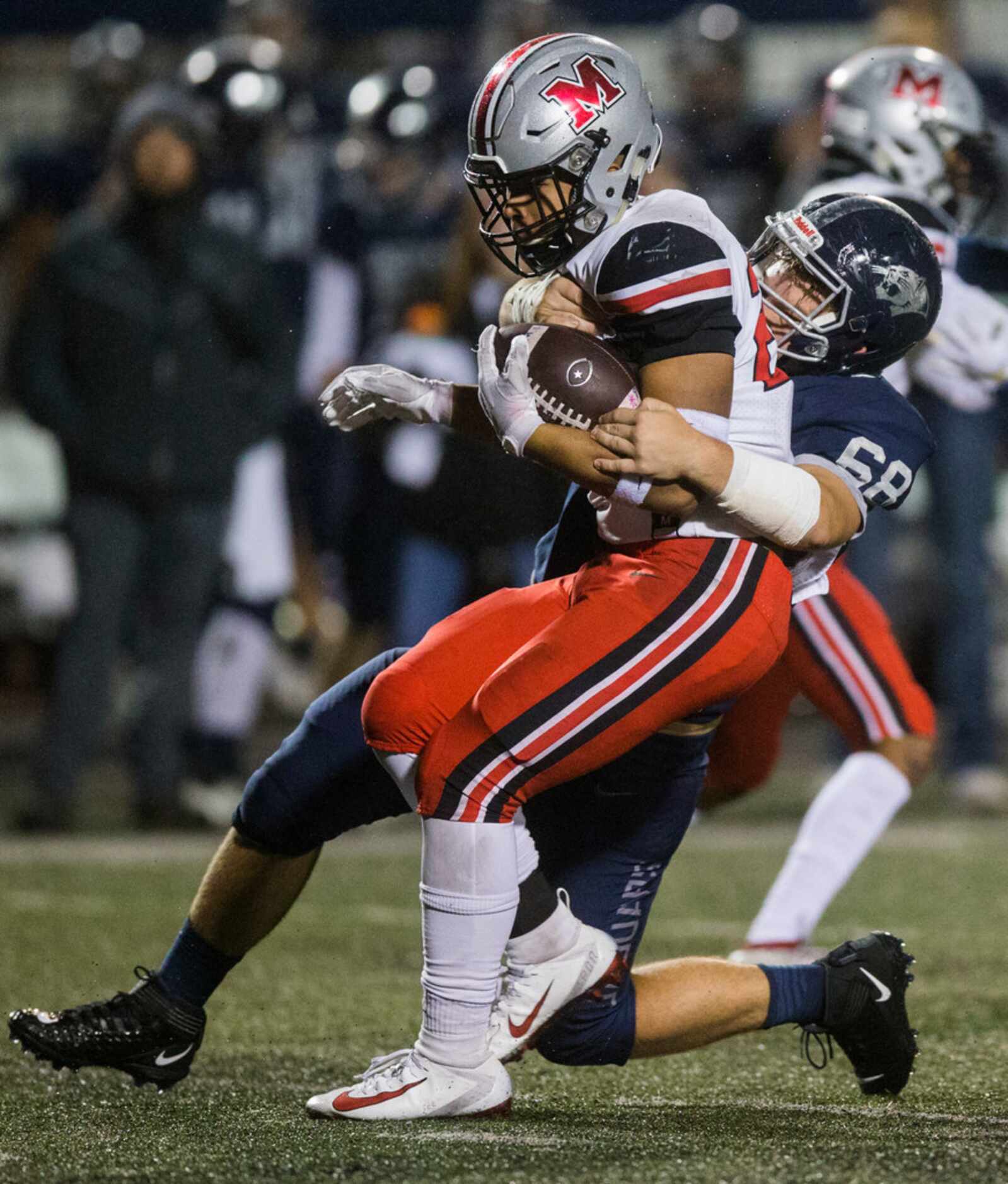 Flower Mound Marcus quarterback Garrett Nussmeier (13) is tackled by Flower Mound lineman...