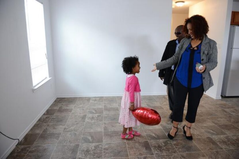 
Ethiopia and Birhanu Tuffa, and their daughter Hamera, 4, stand in the dining room of their...