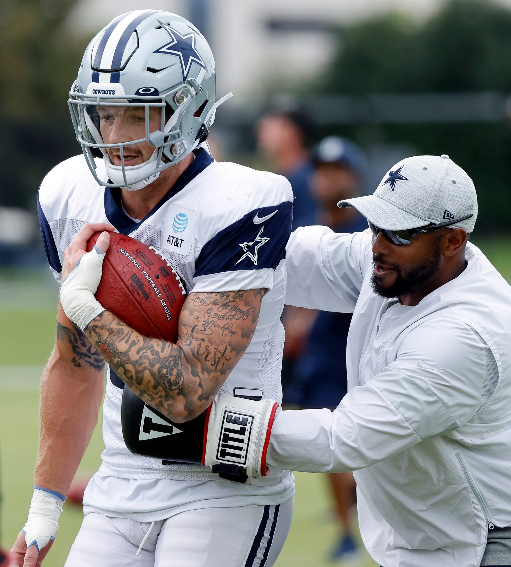 Dallas Cowboys defensive coach Cannon Matthews tries the punch the ball from ight end Peyton...