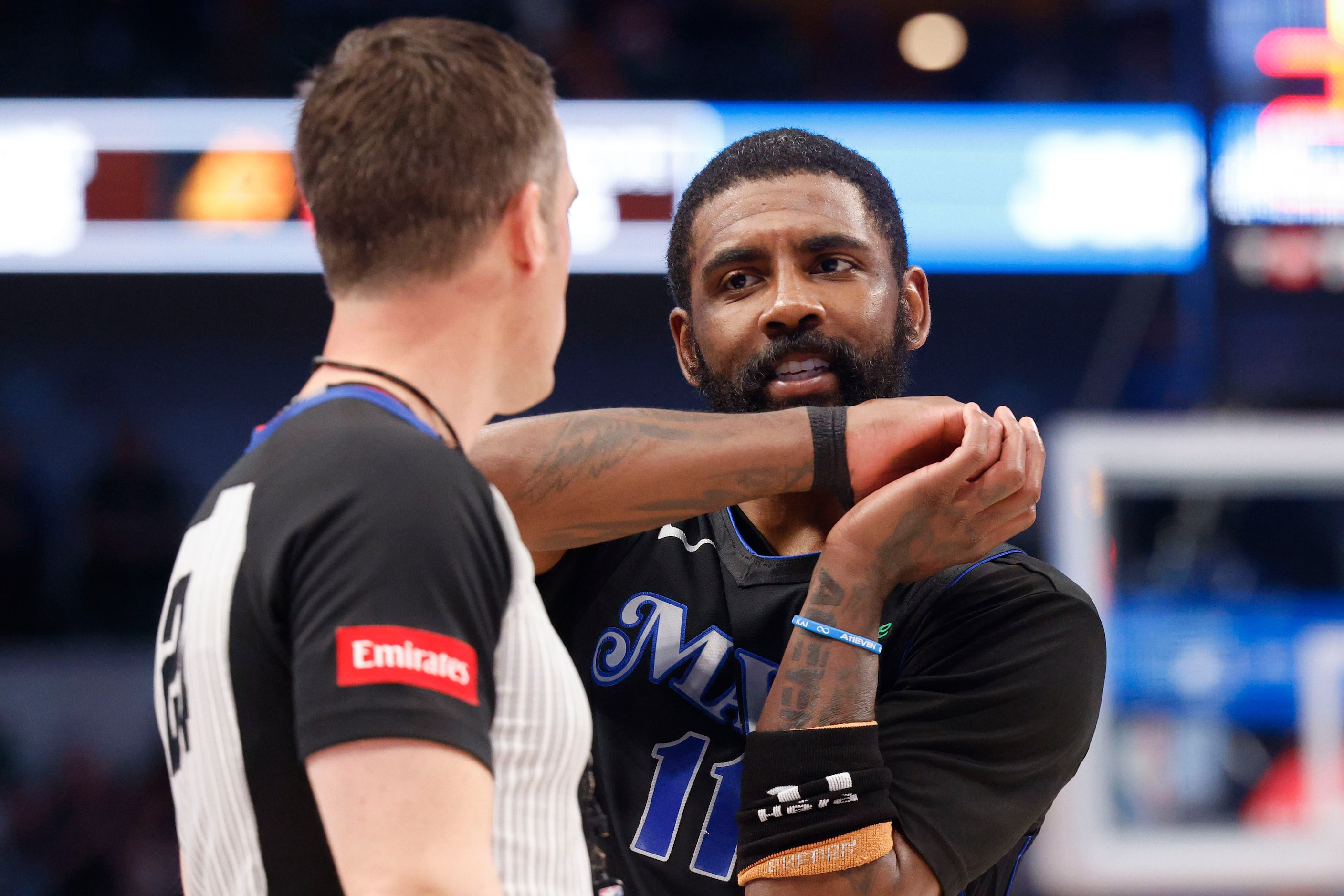 Dallas Mavericks guard Kyrie Irving talks to the referee regarding a foul call during the...