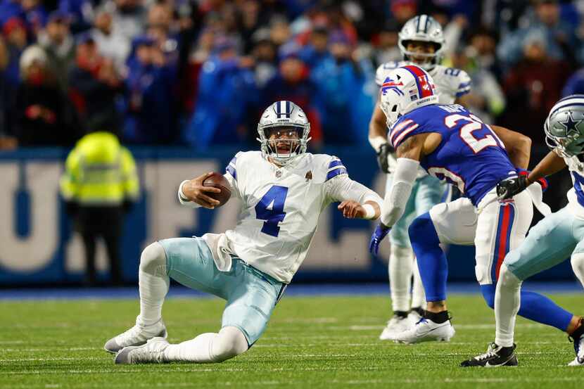 Dallas Cowboys quarterback Dak Prescott (4) slides after running the ball as Buffalo Bills...