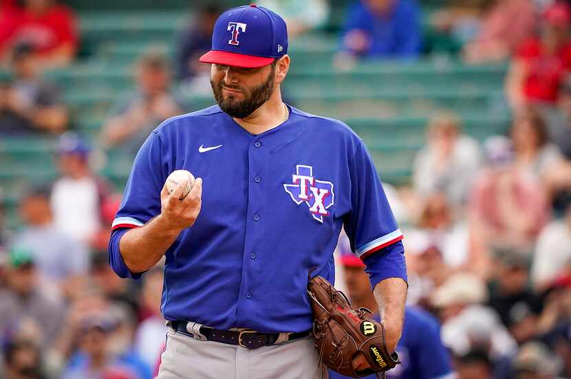 Texas Rangers pitcher Lance Lynn gets a new ball after giving up a run on a single by Los...