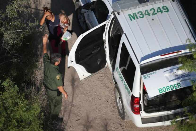 
U.S. Border Patrol agents took immigrants into custody Monday in McAllen. Gov. Rick Perry...