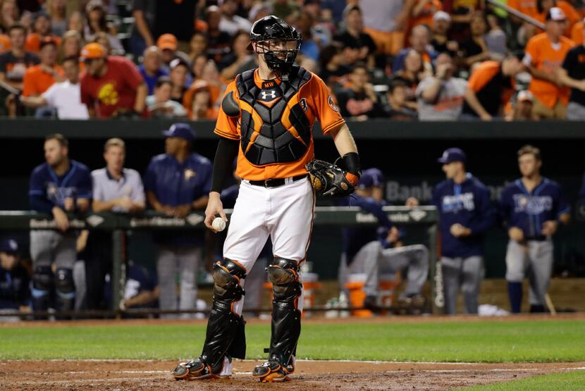 Baltimore catcher Matt Wieters stands on the field during a baseball game against the Tampa...
