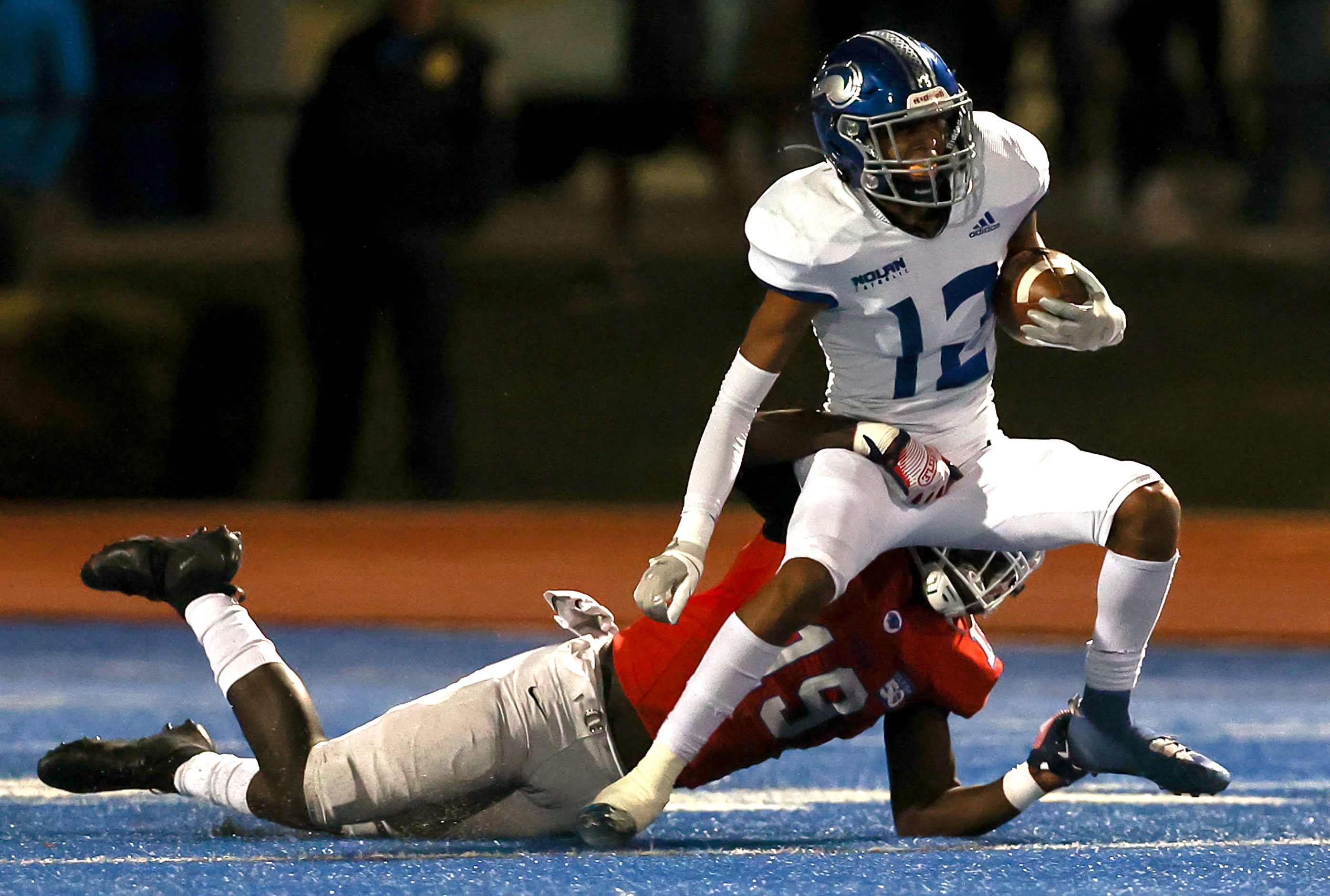 Nolan wide receiver Antonio Hall (12) makes a reception and is brought down by Parish...