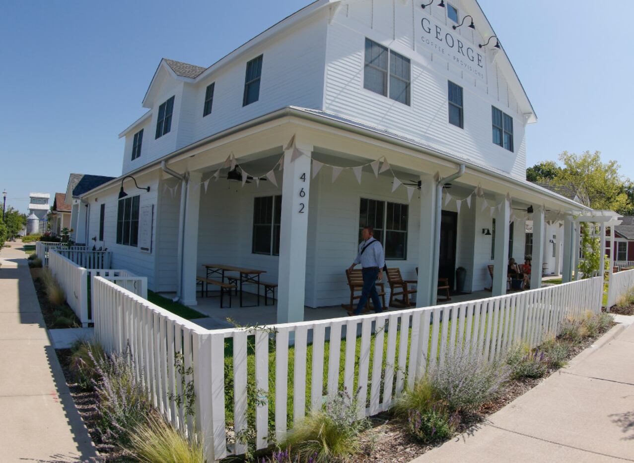 A white picket fence gives George Coffee + Provisions a welcome home feeling and is located...