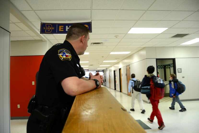 A school resource officer keeps an eye on the hallways at McKinney ISD's Dowell Middle School.