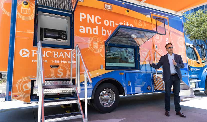 Brendan McGuire explains the features of PNC Bank’s new mobile bank, which is equipped with...