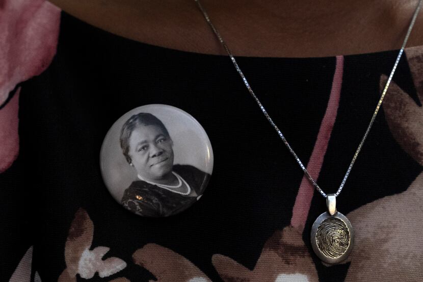A woman wears a pin of Mary McLeod Bethune, during a statue unveiling ceremony in honor of...