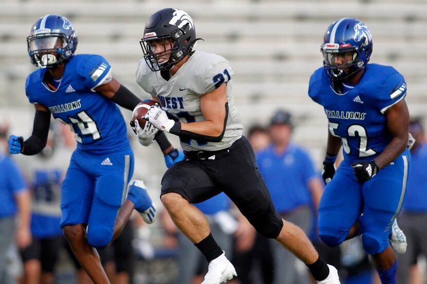 Plano West running back Dermot White (21) sprints to the end zone for a first quarter...