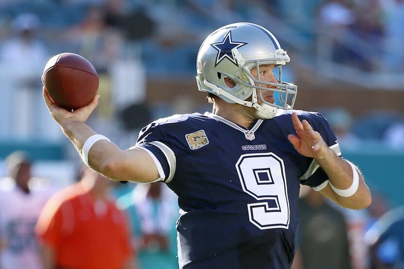 Dallas Cowboys quarterback Tony Romo throws a pass downfield against Miami Dolphins during...