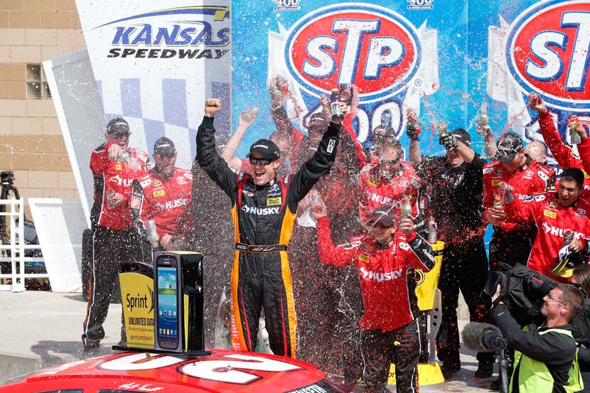 Driver Matt Kenseth (20) celebrates in victory lane after winning a NASCAR Sprint Cup race...