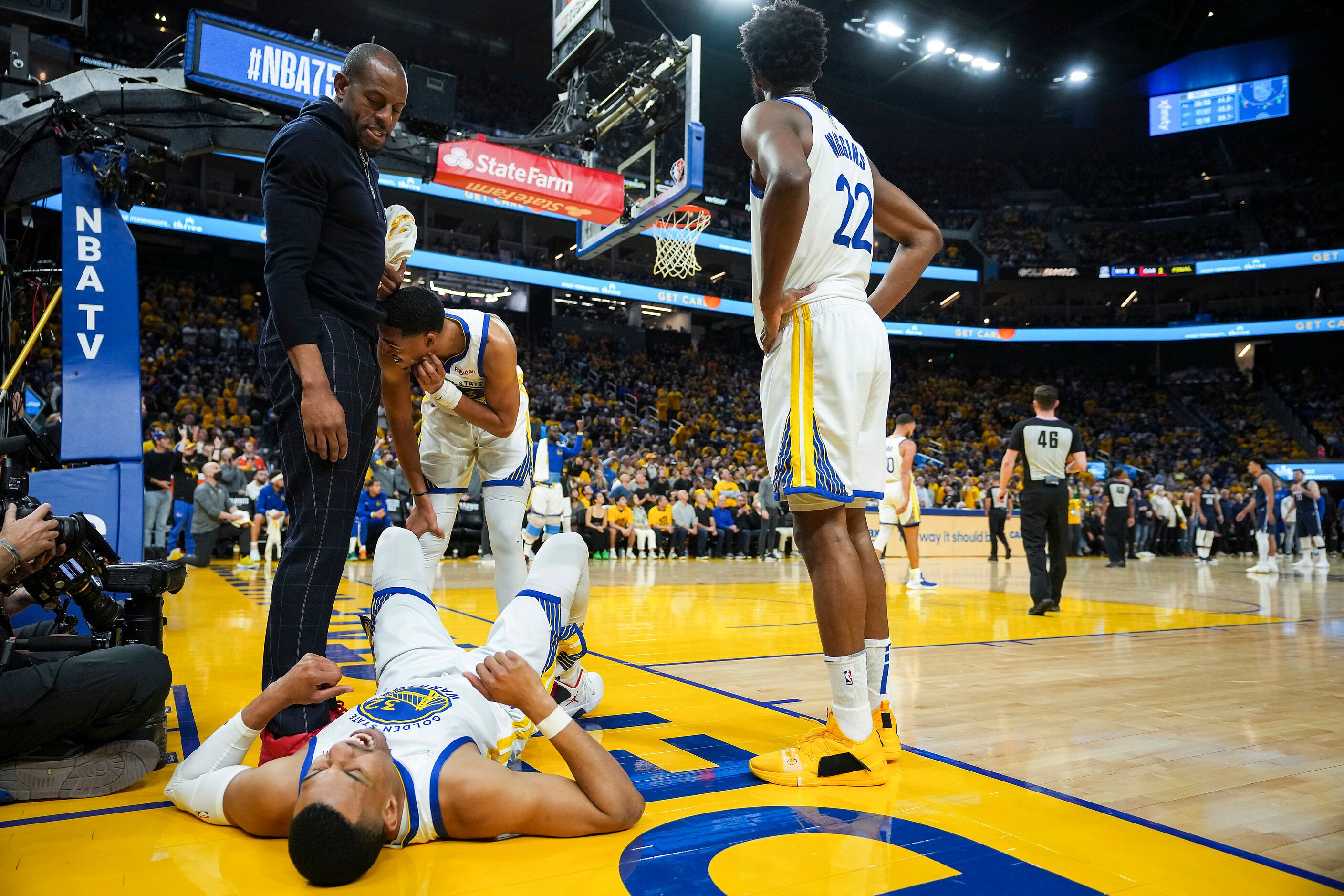 Golden State Warriors forward Otto Porter Jr. (32) grimaces on the floor after being fouled...