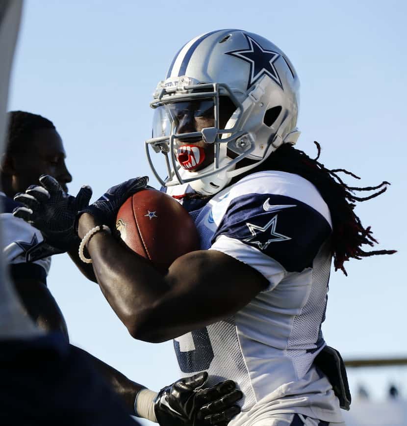 Dallas Cowboys wide receiver Lucky Whitehead (13) carries the ball after making a catch...