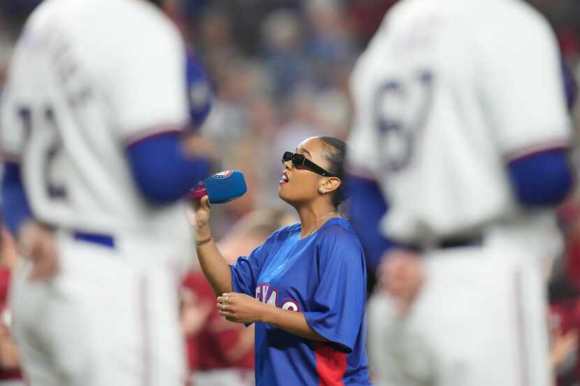 Grammy-winning R&B singer H.E.R. sings the national anthem before Game 1 of the World Series...