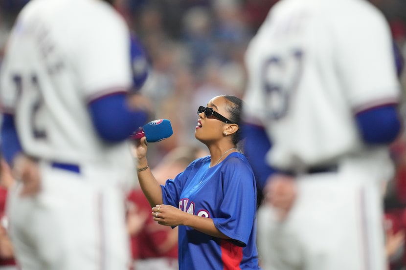 Grammy-winning R&B singer H.E.R. sings the national anthem before Game 1 of the World Series...