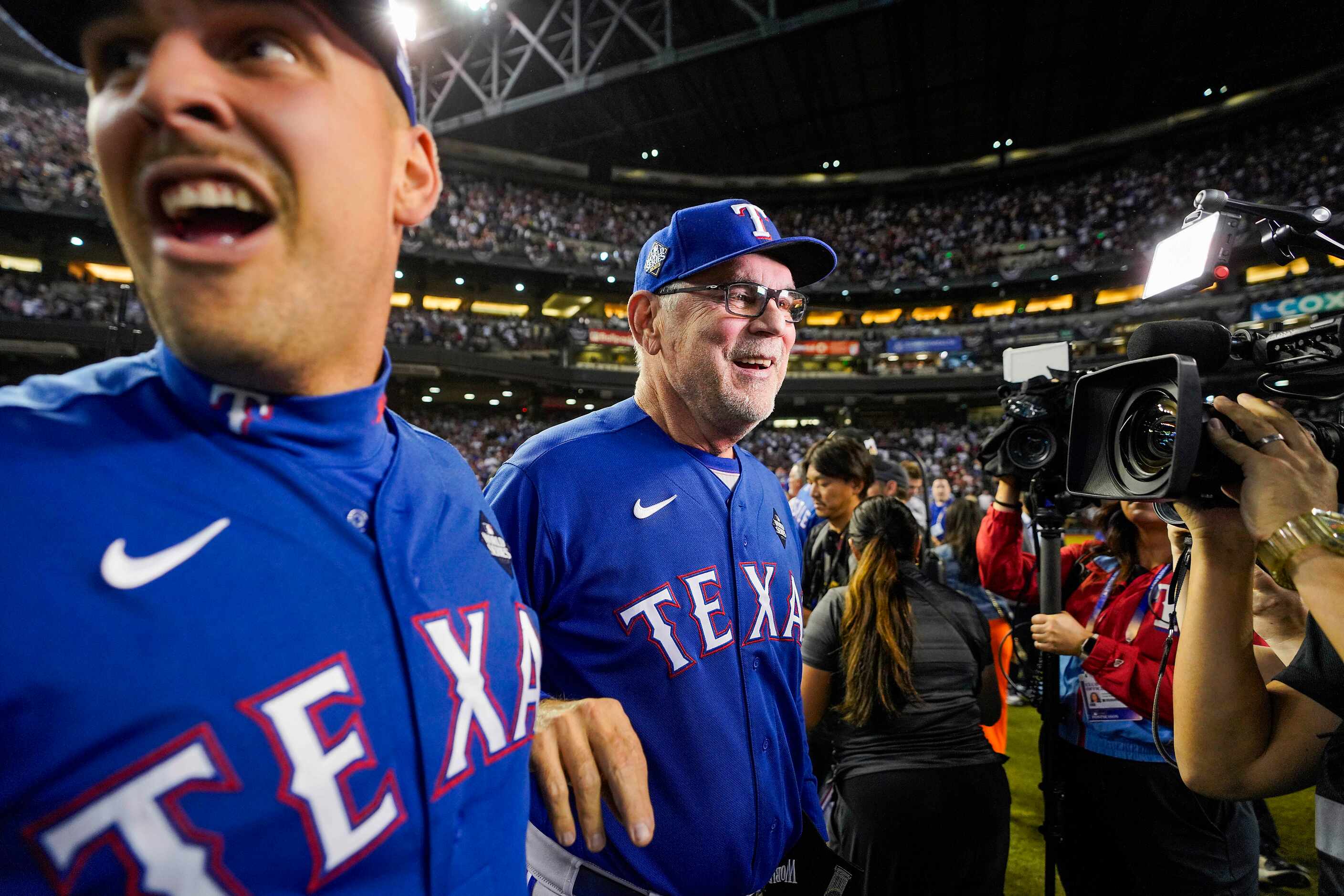 Texas Rangers manager Bruce Bochy, (right) and first baseman Nathaniel Lowe celebrate...
