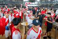 Peru soccer fans dance and sing on the concourse of AT&T Stadium before a Copa America Group...