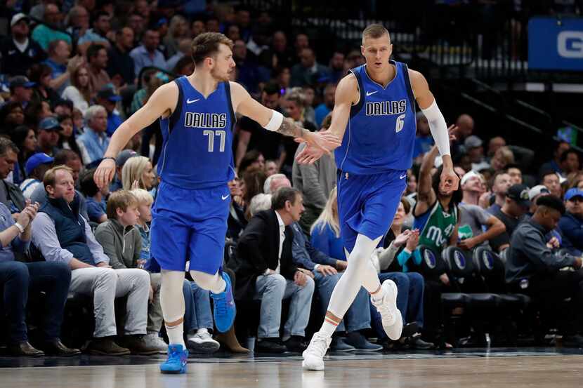 FILE - Mavericks guard Luka Doncic (77) and forward Kristaps Porzingis (6) celebrate a...