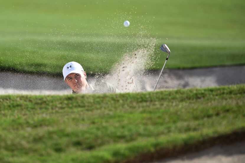 TOPSHOT - US golfer Jordan Spieth hits his ball out of the bunker on the 13th hole during...