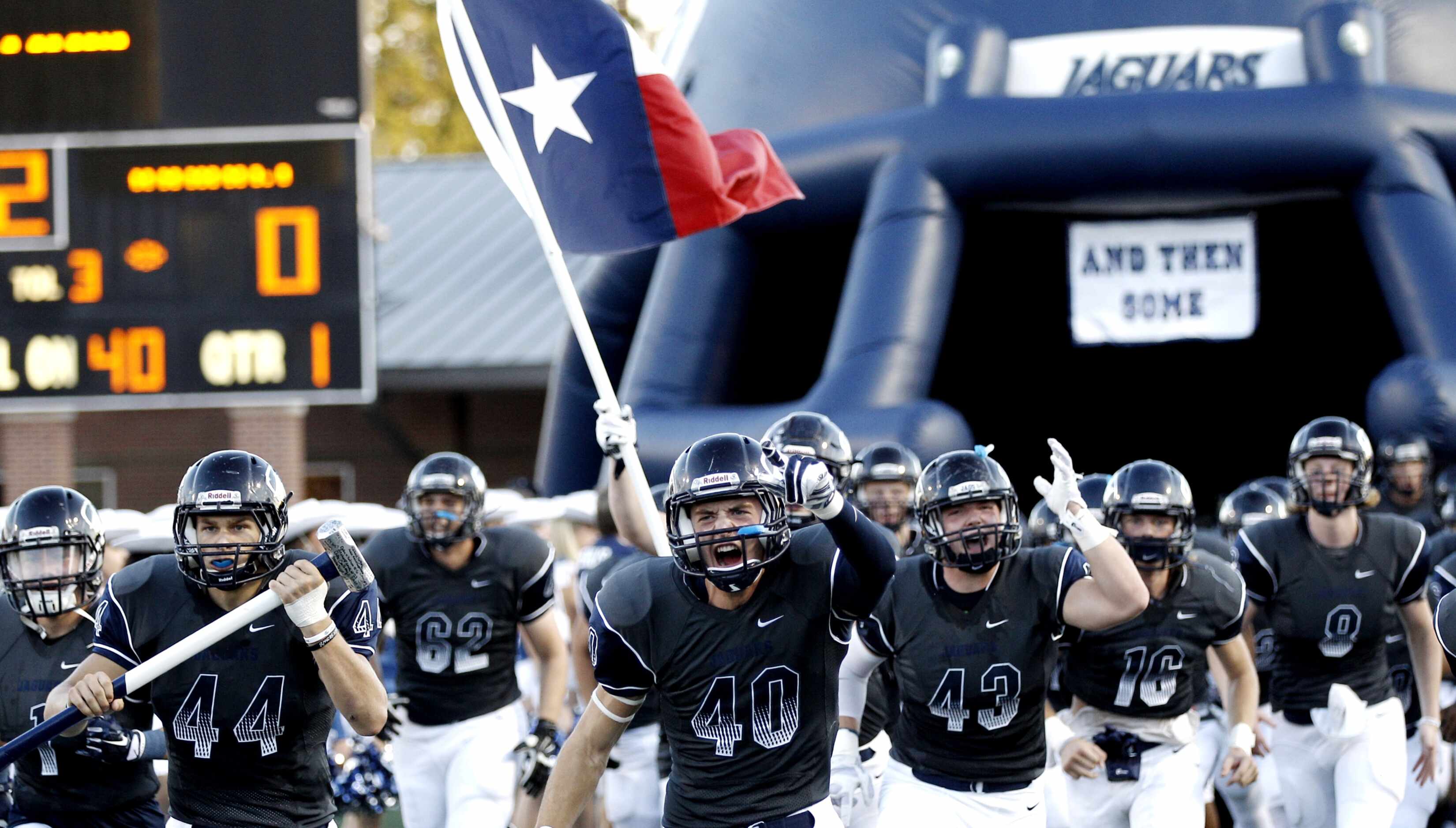 Flower Mounds varsity team takes the field before a high school football game against Keller...