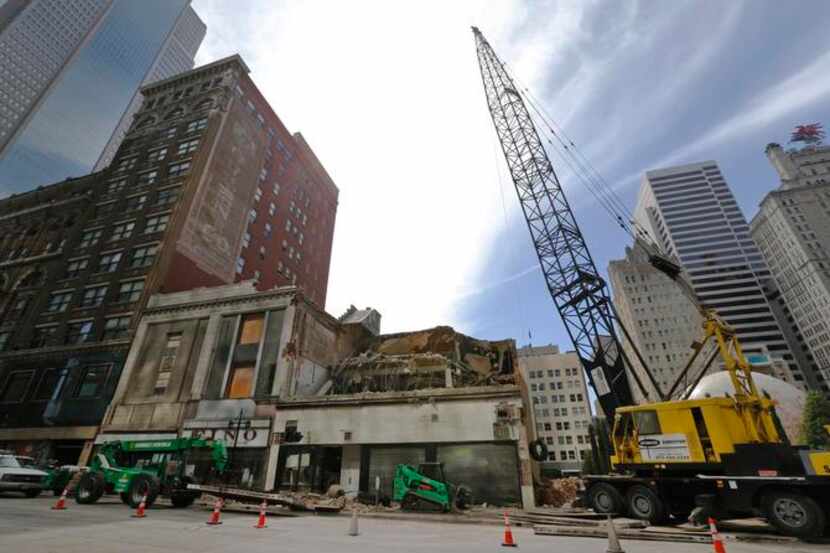 
Demolition crews continued taking down buildings Tuesday on a square block across from the...