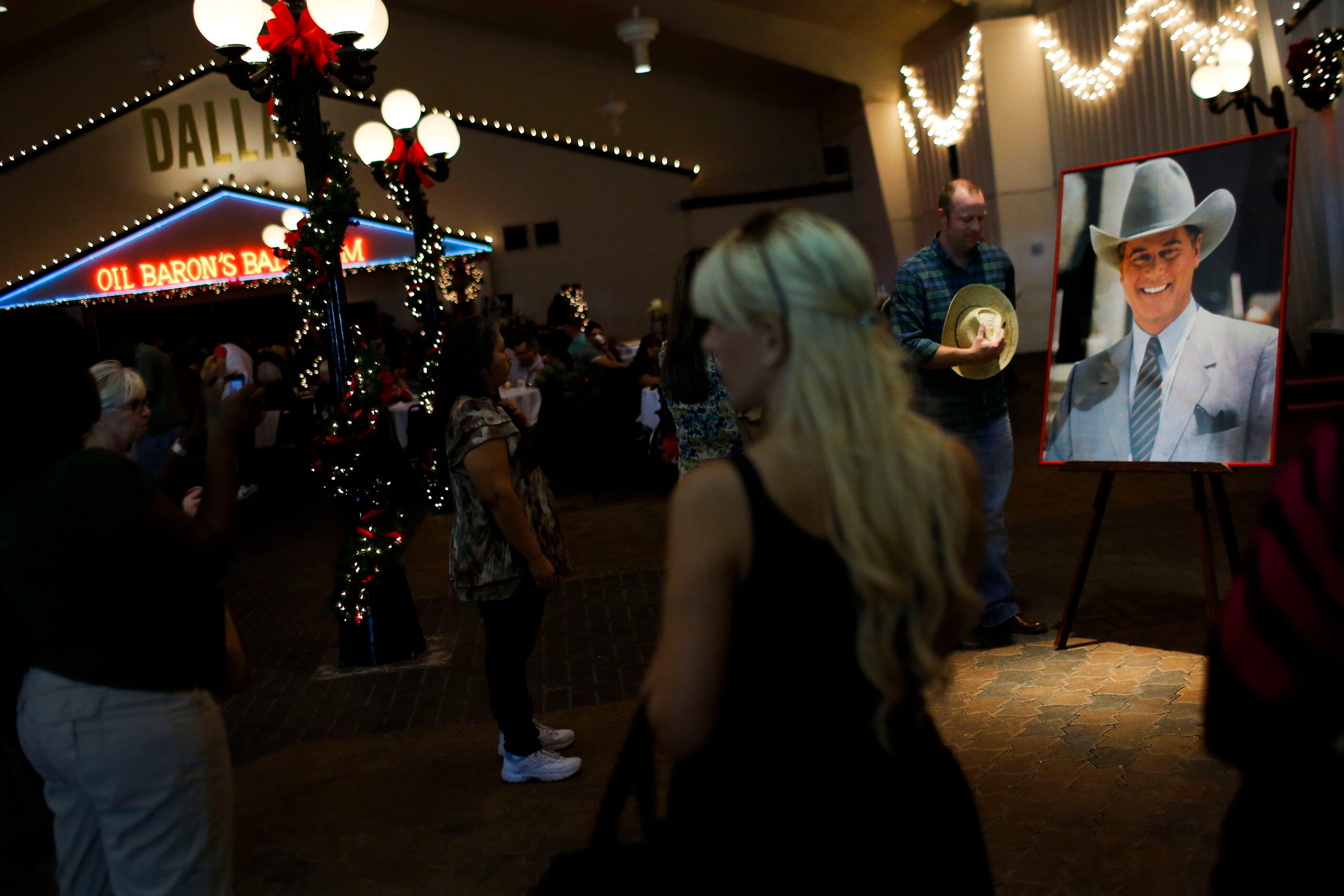 Fans of the show 'Dallas' and those present to pay their respects to Larry Hagman pose for...