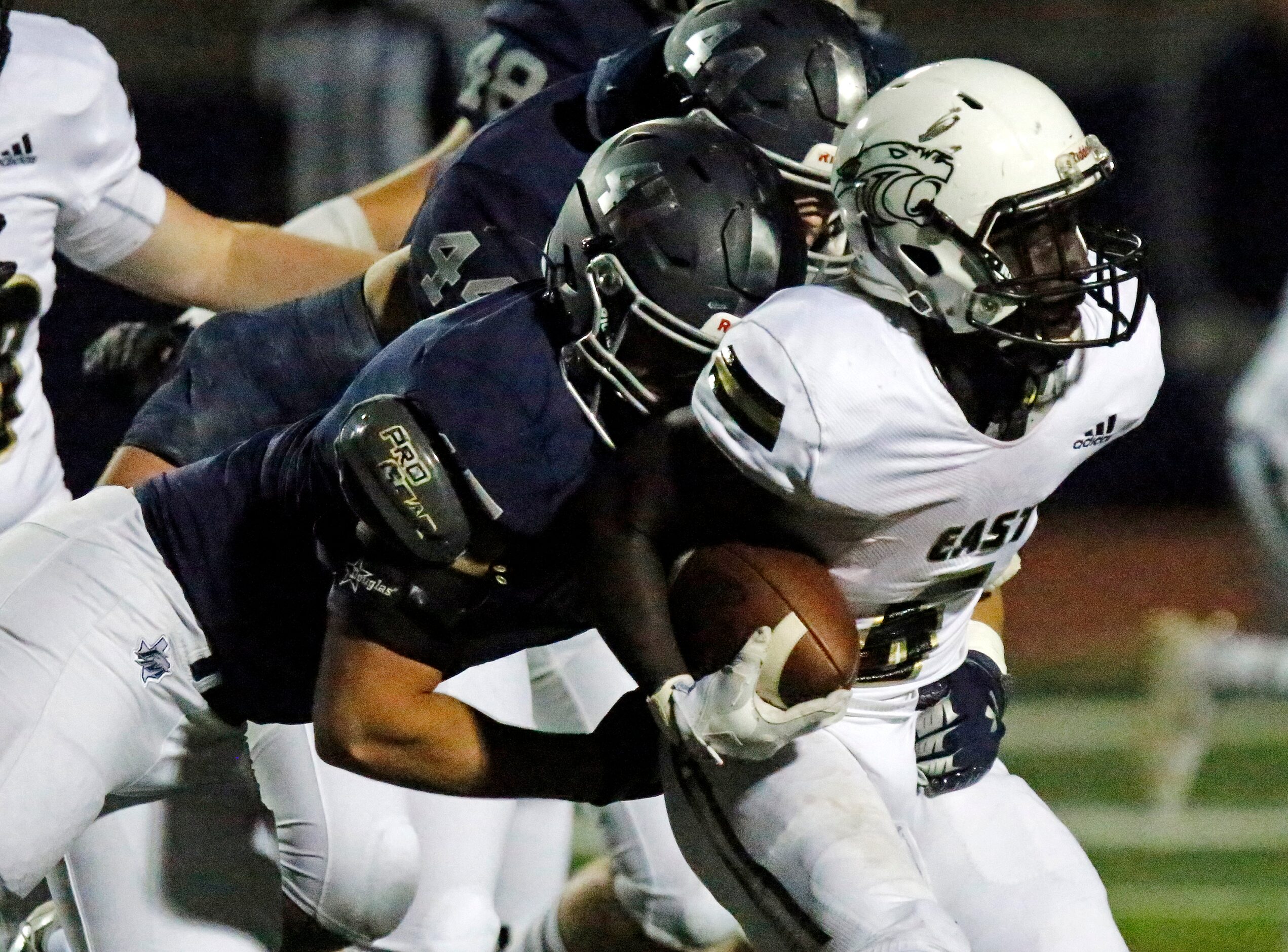 Flower Mound High School defensive tackle George Lancaster (47) tackles Plano East High...