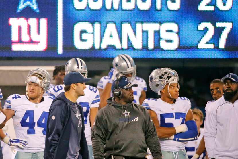Injured Dallas Cowboys quarterback Tony Romo (9) and teammates watch as time runs out in the...